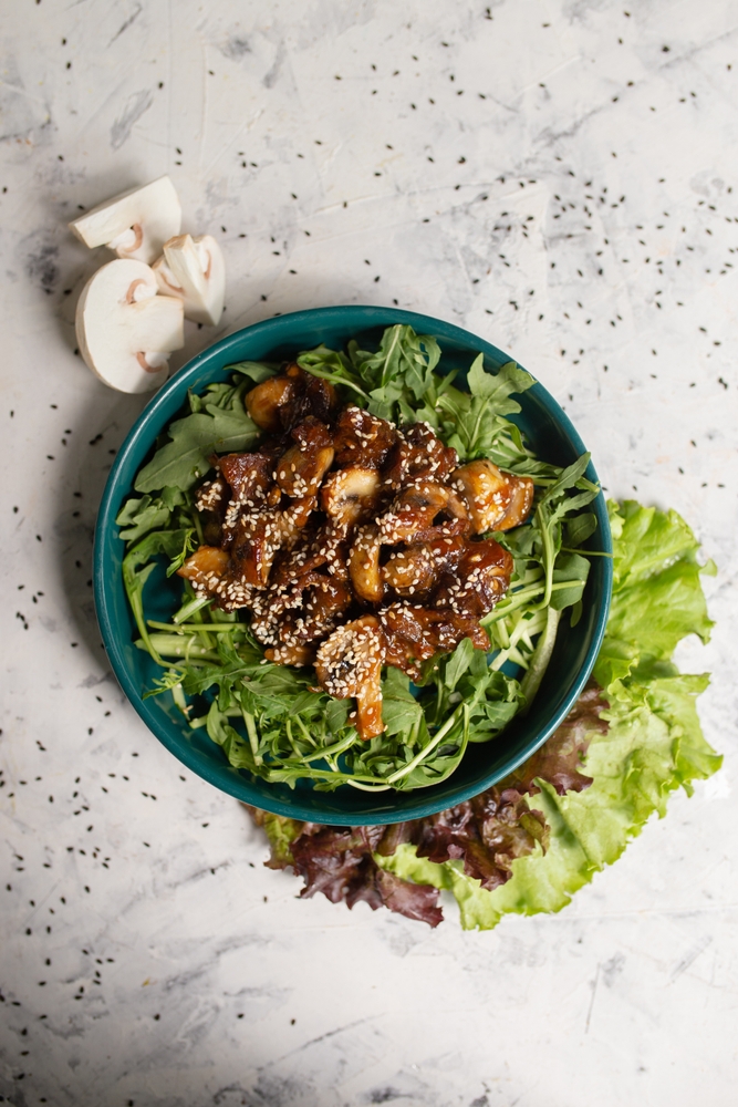 Sliced mushroom in bowl with lettuce