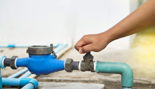 Hand turning off water valve