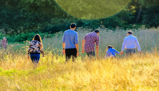 Family members walking through tall grass