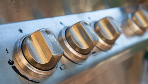 Close-up of temperature dials on a barbecue.