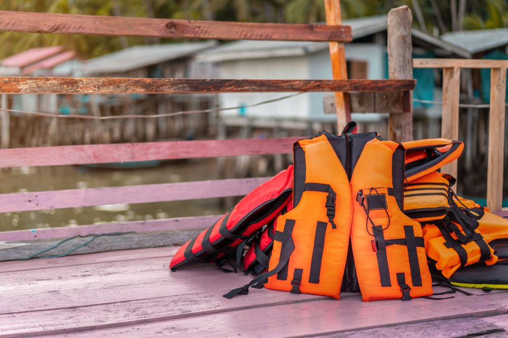 Orange lifejacket on pile of lifejackets