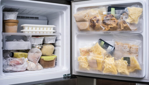 Close-up of a fridge freezer filled with food.