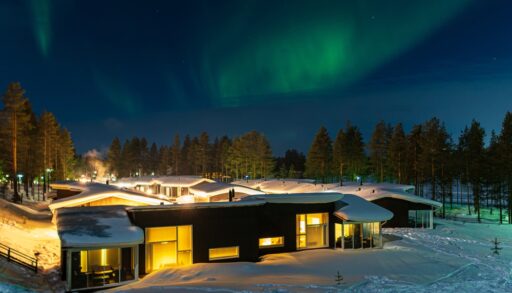 Cottage in snow under northern lights
