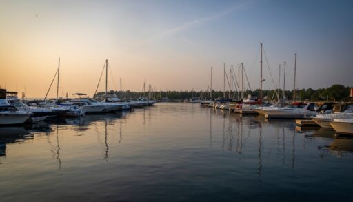 Boats anchored at a pier during sunset.