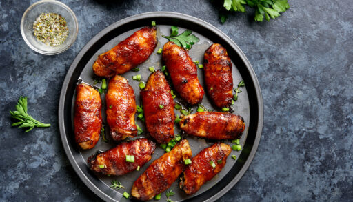 Overhead view of bacon-wrapped chicken wings.