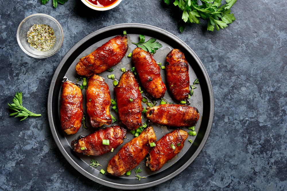 Overhead view of bacon-wrapped chicken wings.