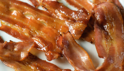 Close-up of candied bacon on a plate.