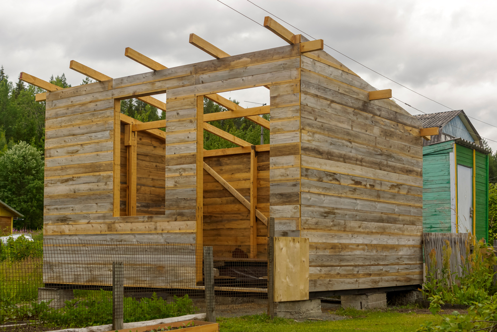Rustic wooden shed under construction.