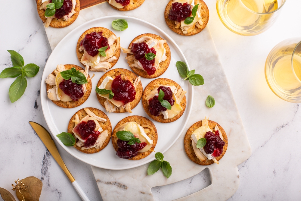Overhead view of turkey crostini with cranberry sauce on top.