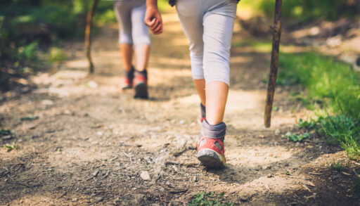 Close-up of children's feet while hiking.