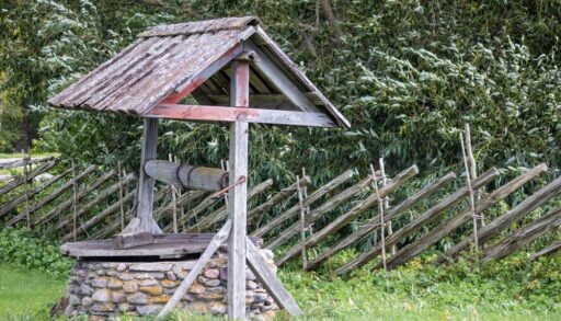 Wooden water well in a forest.