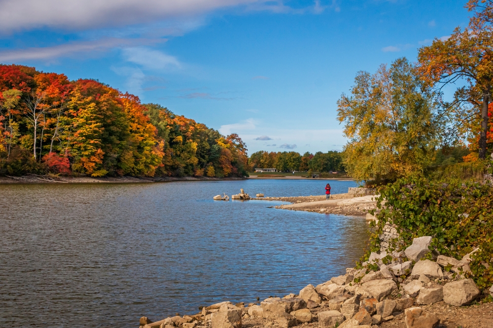 Lake surrounded by red and orange-coloured trees.