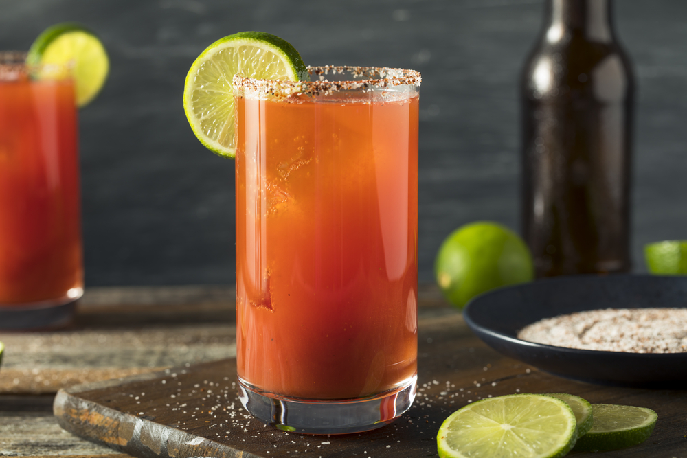 Homemade Michelada on a wooden serving board.