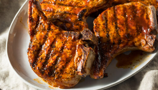 Close-up of grilled pork chops on a plate.