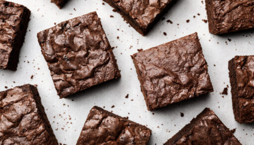 Overhead view of fudgy brownies on a white background.