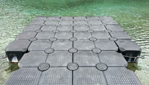 Close-up of a grey modular dock on a lake.