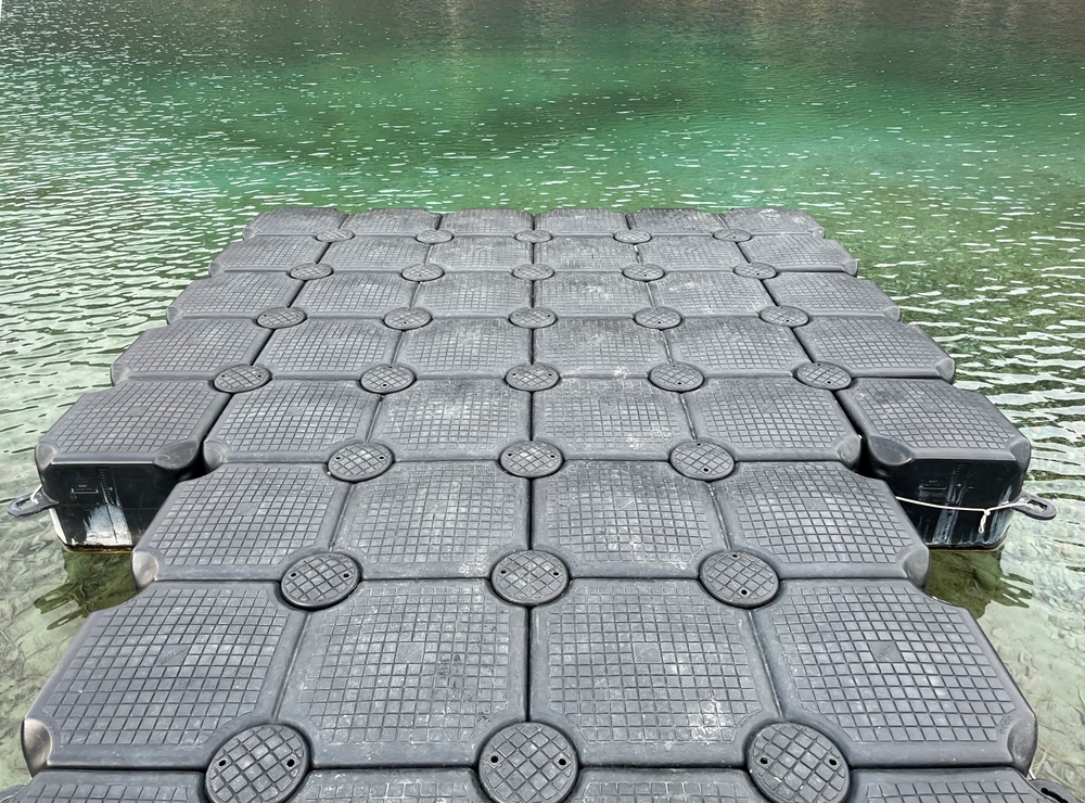 Close-up of a grey modular dock on a lake.