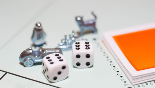 Close-up of Monopoly game board with dice and game pieces.
