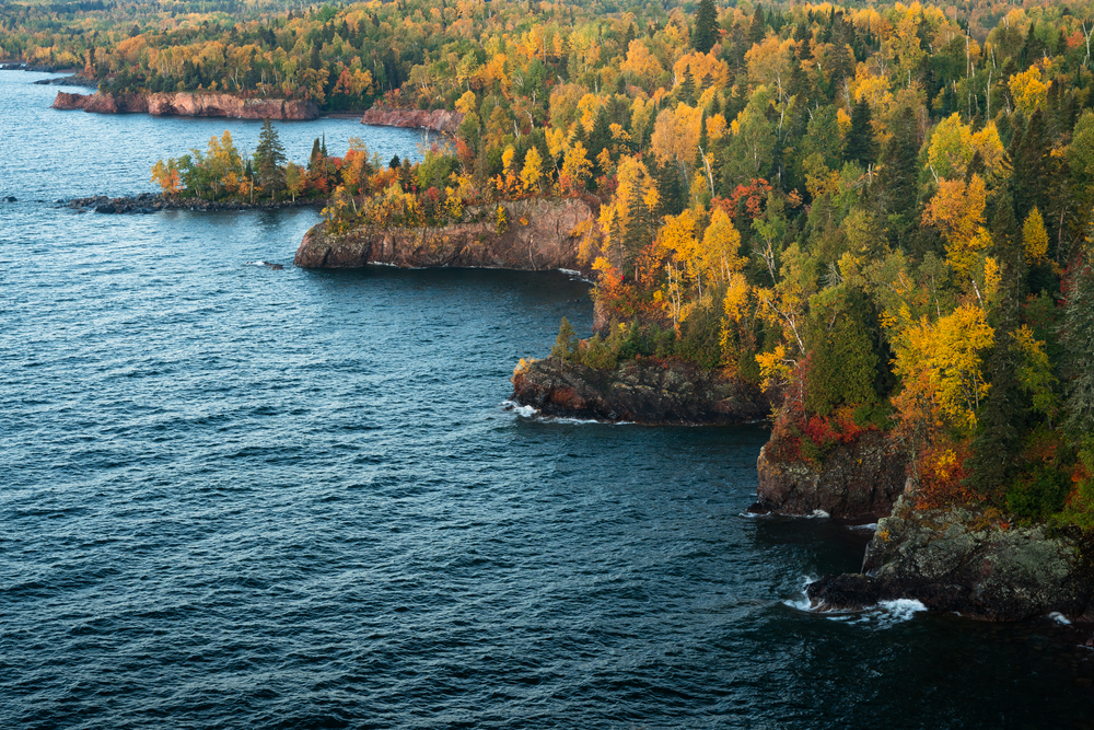Aerial view of fall foliage along the shore of Lake Superior.