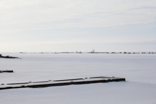 Snow-covered dock on a frozen Lake Huron.