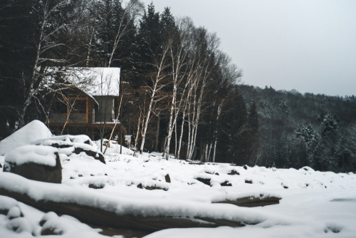 Snowy cottage next to the frozen Eagle Lake, Ontario.