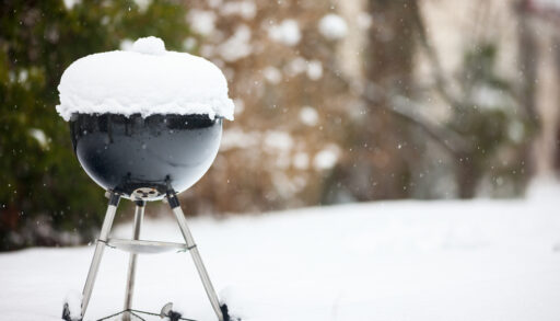 Black grill covered in snow.