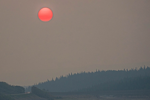 Red sun on a hazy lake.