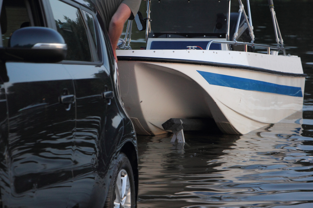 Blue and white boat being put in the water.