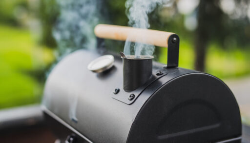 Close-up of smoke coming from a black smoker.