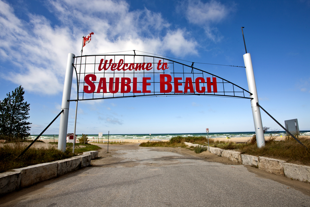 Red Sauble Beach sign over the entrance to the beach.