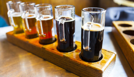 Line of beers on a tray.