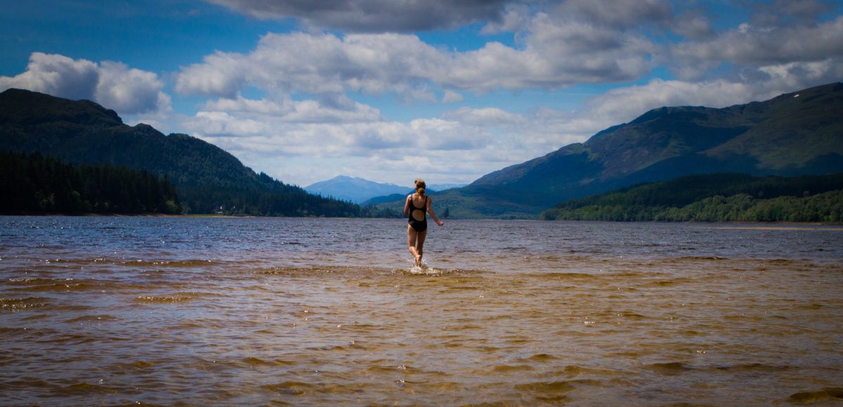 woman-walking-into-lake