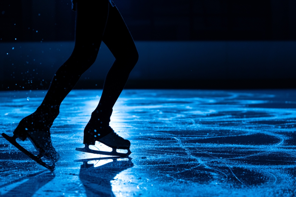 Silhouette of a female figure skater's skates.