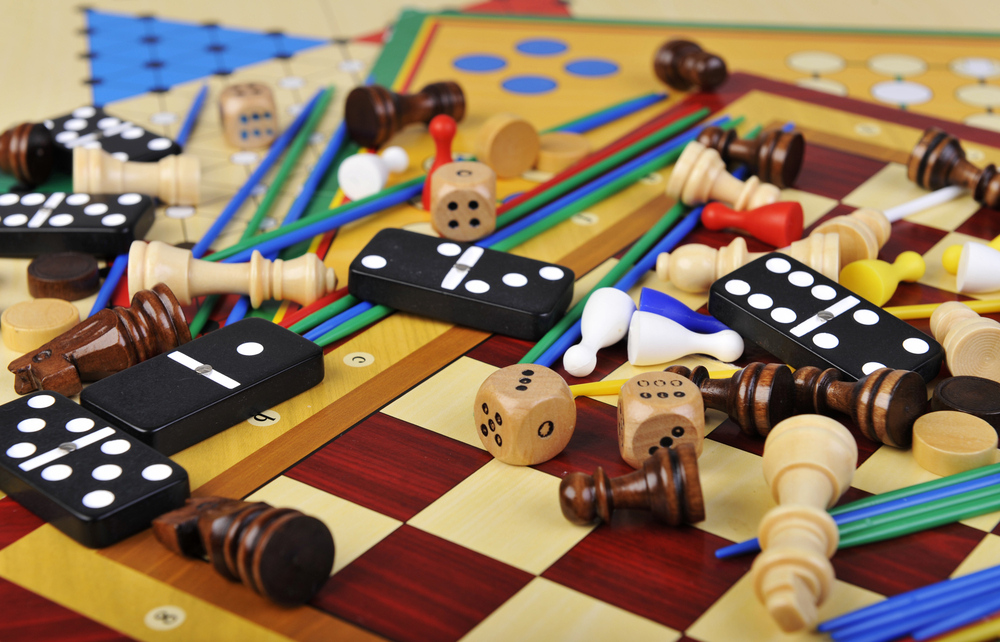 Various boardgame pieces spread across a table.