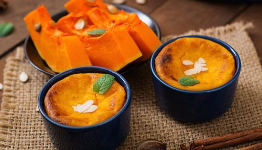 Cottage cheese and pumpkin pudding with cinnamon and nutmeg on wooden background