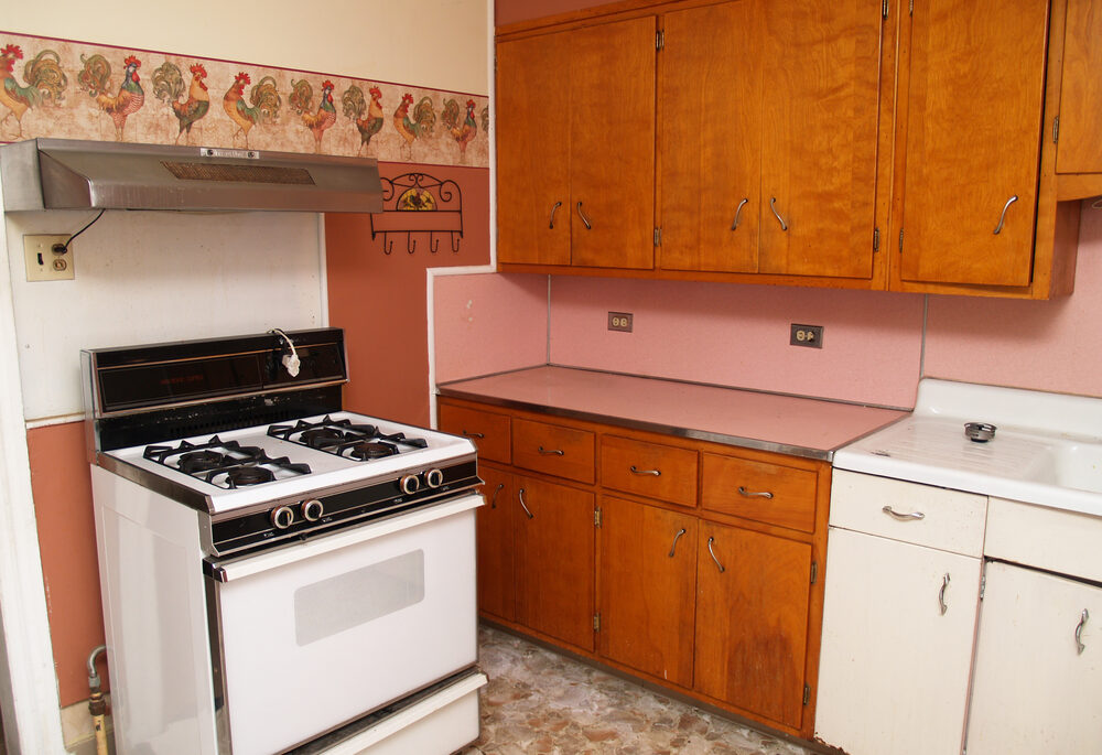 old kitchen with older appliances and wood cabinets