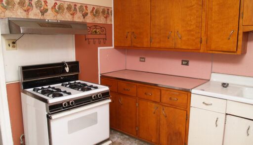 old kitchen with older appliances and wood cabinets