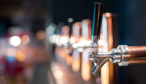 Close-up of a beer tap in a row at a bar.