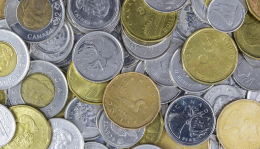 Pile of Canadian coins, including loonies, toonies, quarters and nickels.