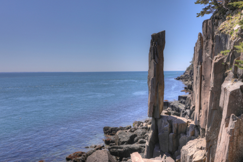 Vertical rock balancing on another near the ocean in Digby Neck, Nova Scotia, Canada.