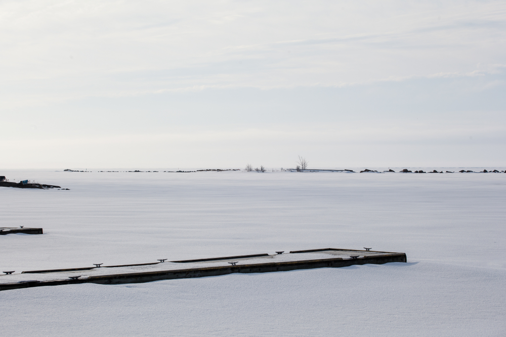 Snow-covered docks along a frozen Lake Huron.