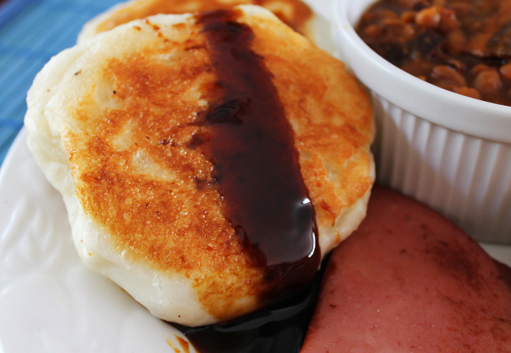 Touton (fried bread) covered in molasses.