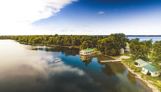 Aerial view of cottages along a lake in Prince Edward County, Ontario.