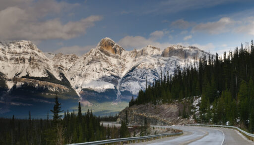 Road along the Icefields Parkway mountains in Alberta, Canada.