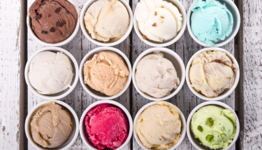 Overhead view of cups with different flavours of ice cream.