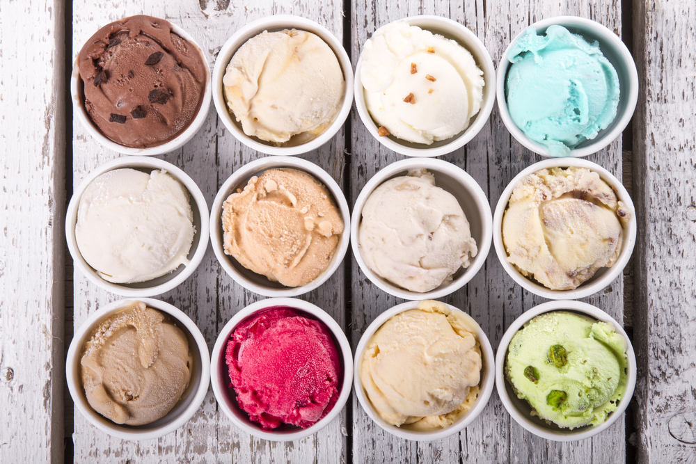 Overhead view of cups with different flavours of ice cream.