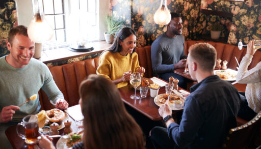 Group of people eating in a restaurant.