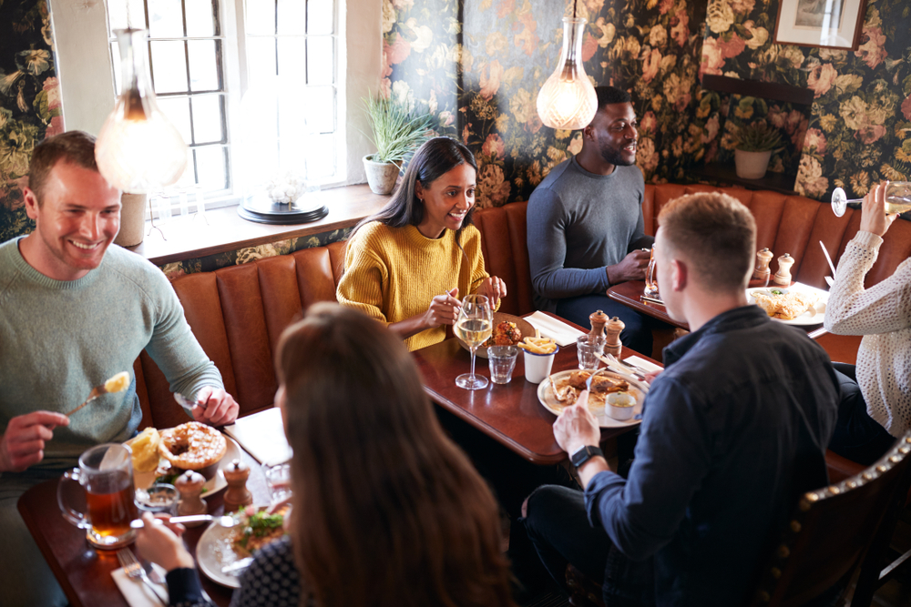 Group of people eating in a restaurant.
