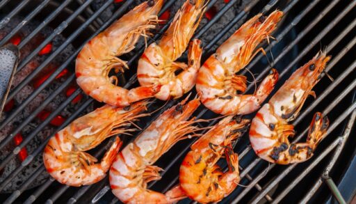 Overhead close-up of shrimp on the grill.