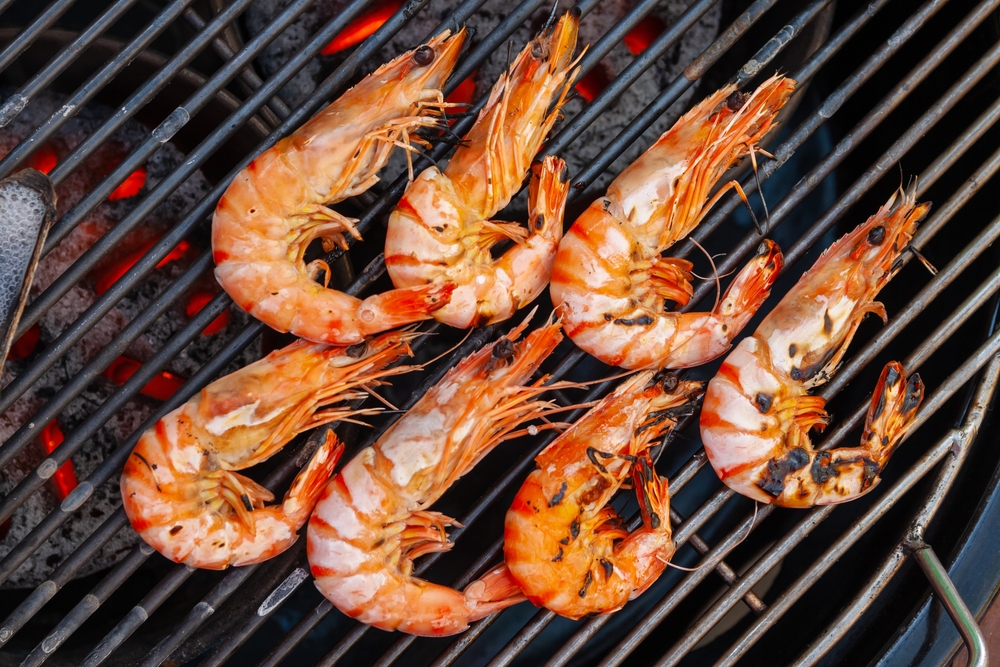 Overhead close-up of shrimp on the grill.